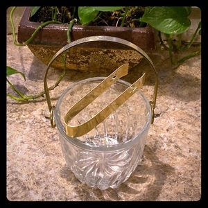 Glass Ice bucket with gold color plated trim.